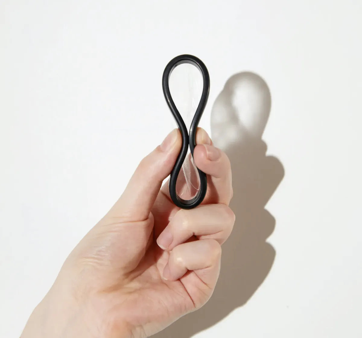 A hand pinching a Flex Disc by the middle to show insertion technique