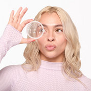 A person holding a flex plant plus menstrual disc