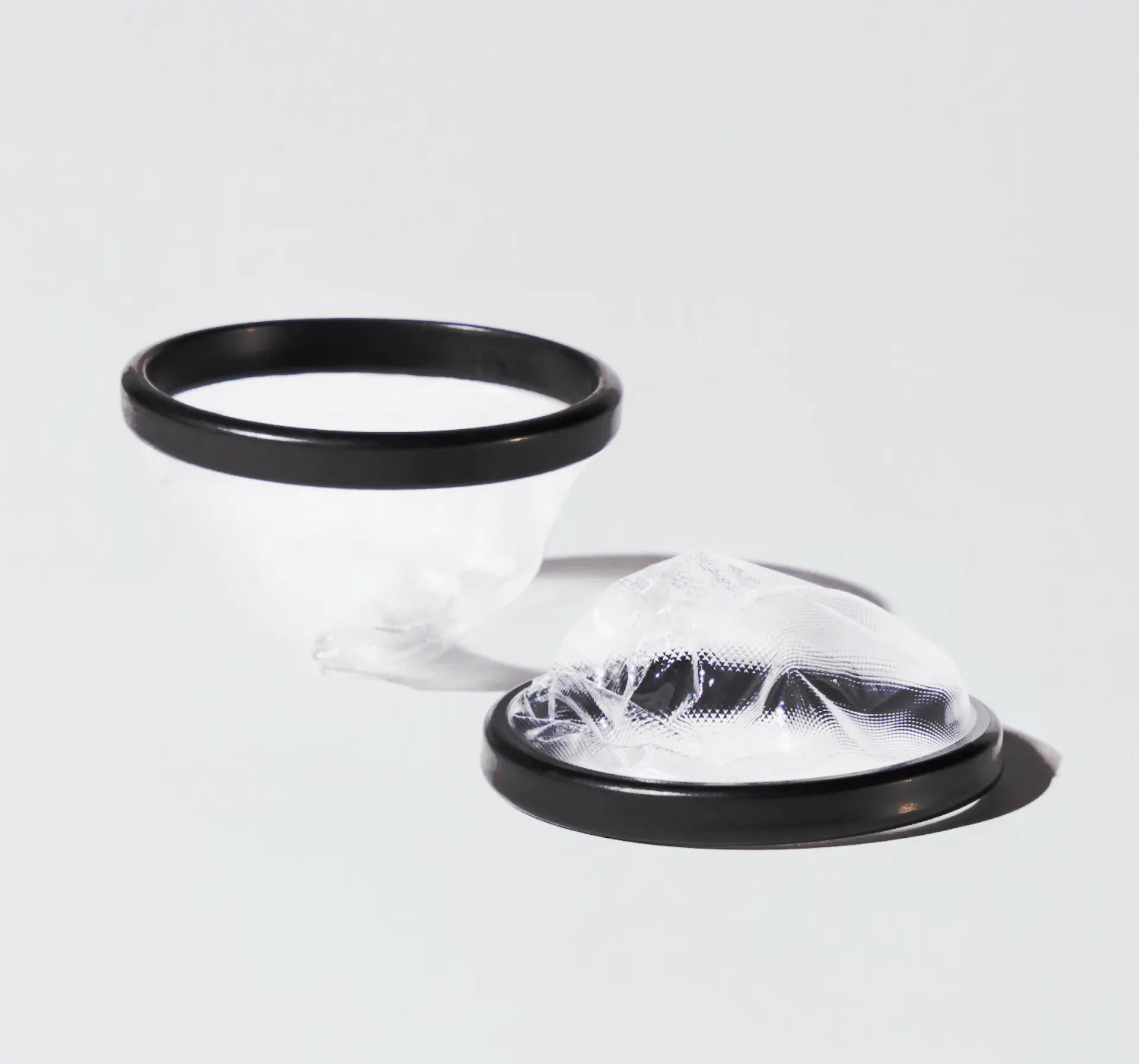 Two Flex Disposable Menstrual Discs on a white table